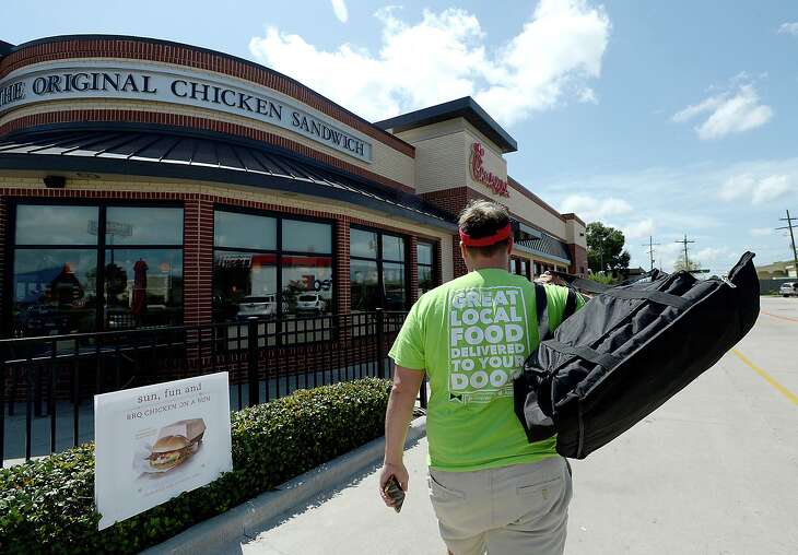 Donny Avery makes his way into Chick-fil-a to pick up a customer order while spending his Saturday driving for Waitr. It is among the side jobs that Avery has in addition to his full time job at the Regional Visitor's Center. Photo taken Friday, August 11, 2017.