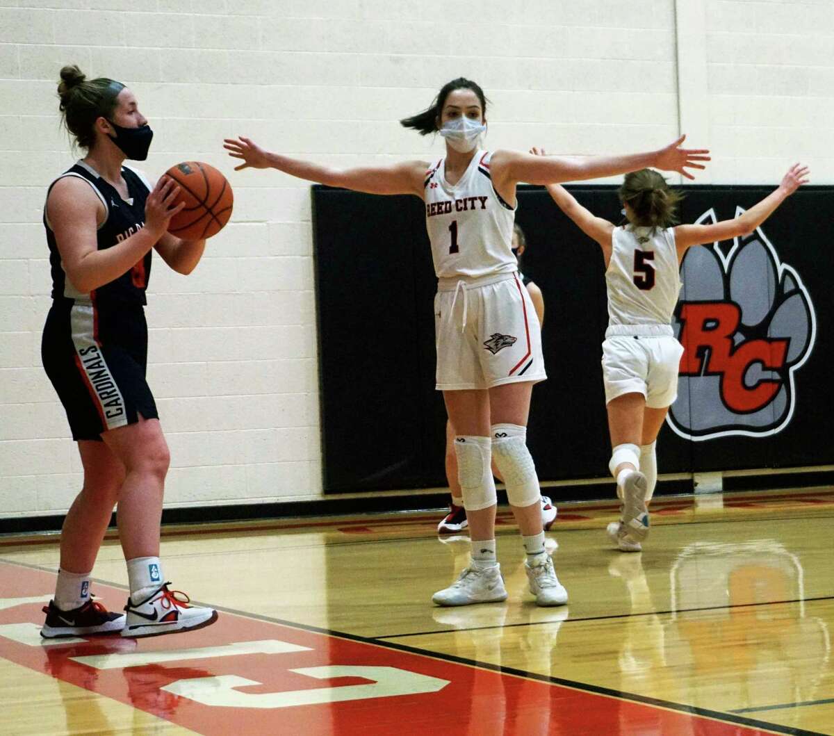 Big Rapids sophomore Rylie Haist (left) looks to inbound the ball during a game on Tuesday night as Reed City's (name) gets ready to defend. (Pioneer photo/Joe Judd)