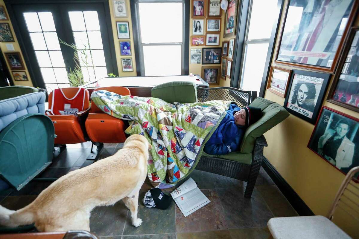 Heights resident Todd Green huddles beneath multiple blankets as he tries to stay warm in his home without power and running water, in Houston, Wednesday, February 17, 2021, after a winter storm left people without power and water along with freezing temperatures.