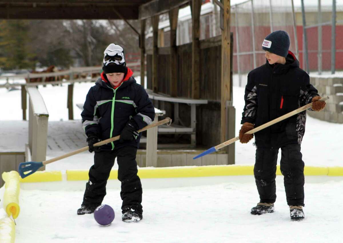In this Jan. 24, 2021 file photo, a couple of broomball players adjust their footing before resuming play during an intense game held at Winterfest. CranHill Ranch will host a second installment of Winterfest this Sunday. (Pioneer file photo)