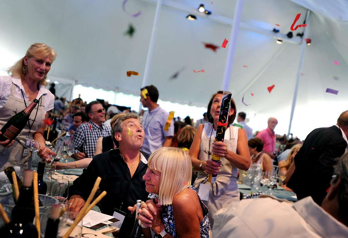 Mitch Soekland and Mary Miner celebrate after winning Lot 10 for $55 thousand during Auction Napa Valley 2012 held at Meadowood resort in St. Helena, California. June 2, 2012.