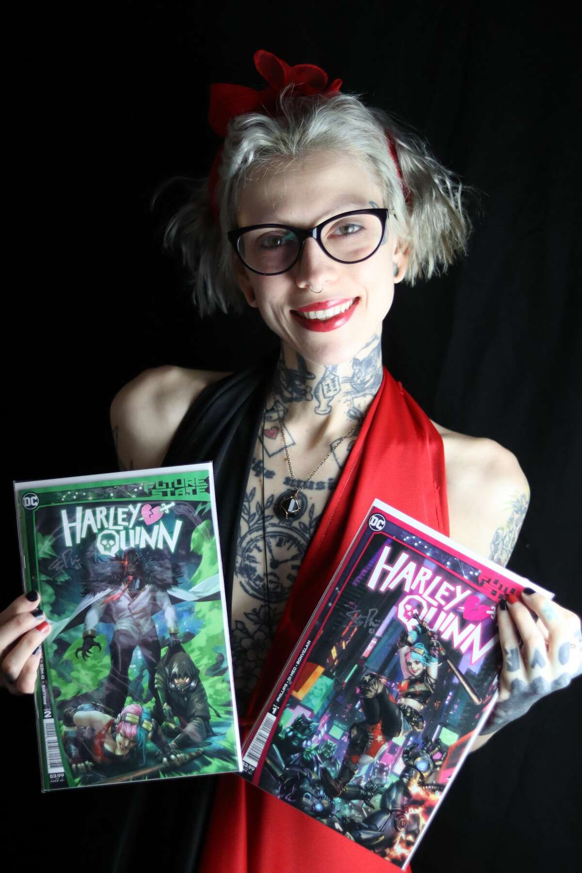 Janna aka Sweetheart.Harley, holds copies donated and autographed by author Stephanie Phillips, that are being raffled to benefit the National Coalition Against Domestic Violence