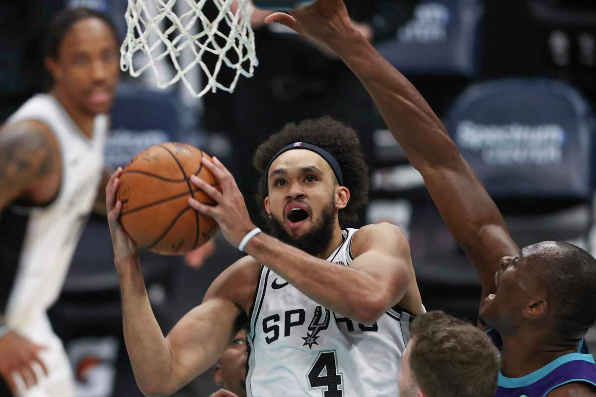 San Antonio Spurs guard Derrick White drives to the basket against the Charlotte Hornets during the second half of an NBA basketball game in Charlotte, N.C., Sunday, Feb. 14, 2021. San Antonio won 122-110. (AP Photo/Nell Redmond)