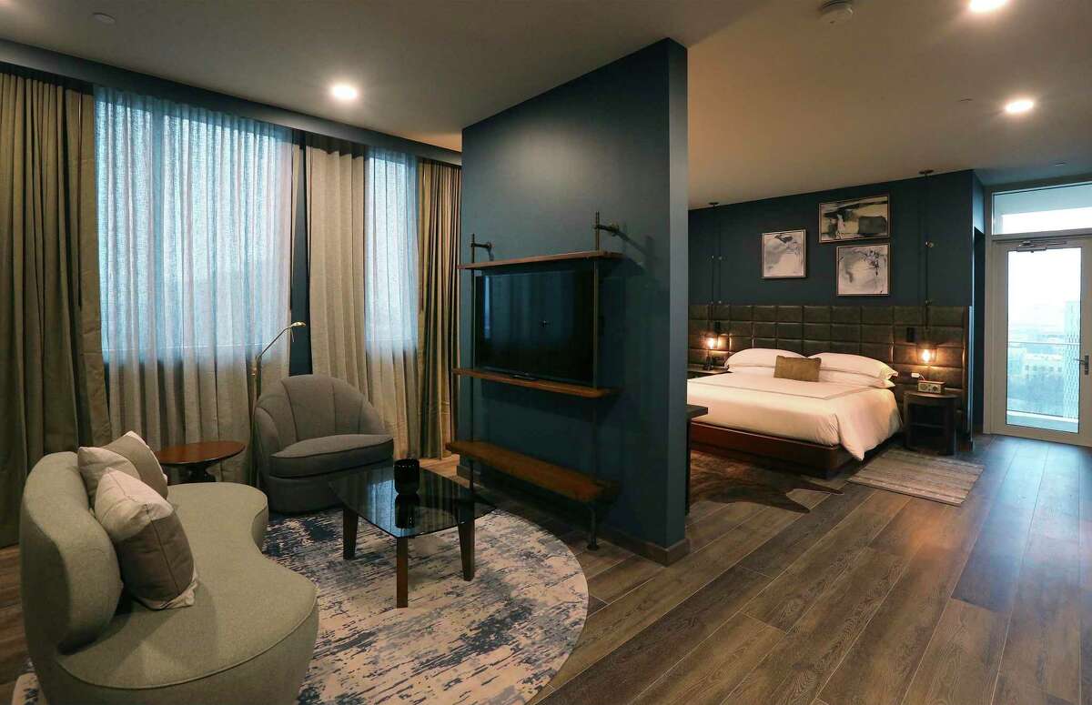 The hotel rooms at the Thompson San Antonio hotel reflect the same design elements as are found in the lobby area, with comfortable seating, hardwood flooring, rugs and the occasional animal hide.