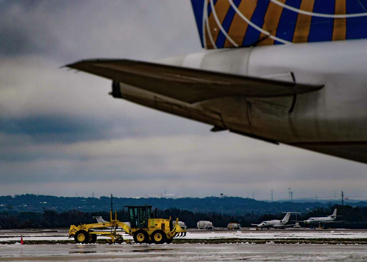 Heavy equipment removes snow from the runways and taxiways at San Antonio International Airport on Wednesday, Feb. 17, 2021. The airport has been closed since Monday due to snow and extreme cold weather.