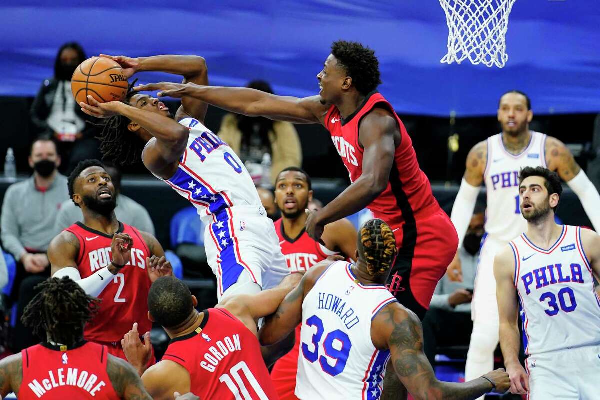 Philadelphia 76ers' Tyrese Maxey (0) goes up for a shot against Houston Rockets' Jae'Sean Tate during the second half of an NBA basketball game, Wednesday, Feb. 17, 2021, in Philadelphia. (AP Photo/Matt Slocum)