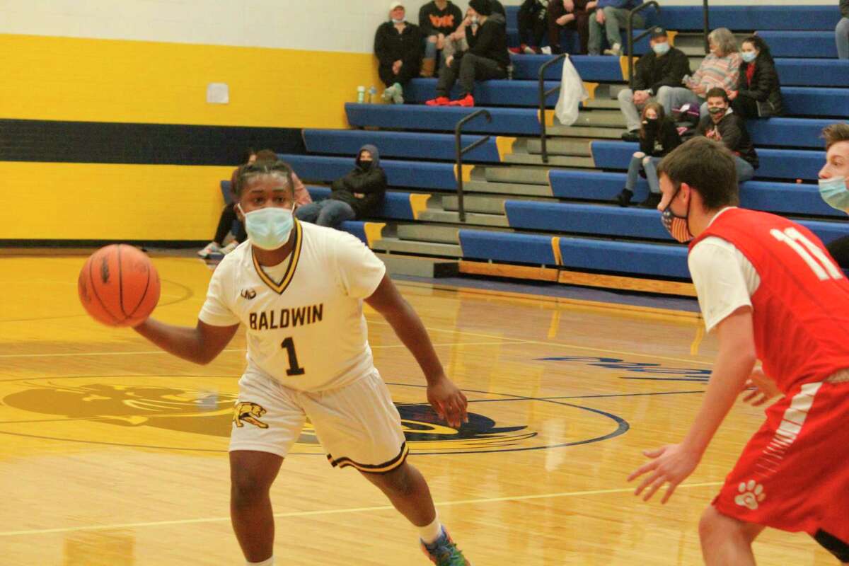 Baldwin's Chris Brown (1) looks to make the pass against Crossroads on Friday. (Star photo/John Raffel)