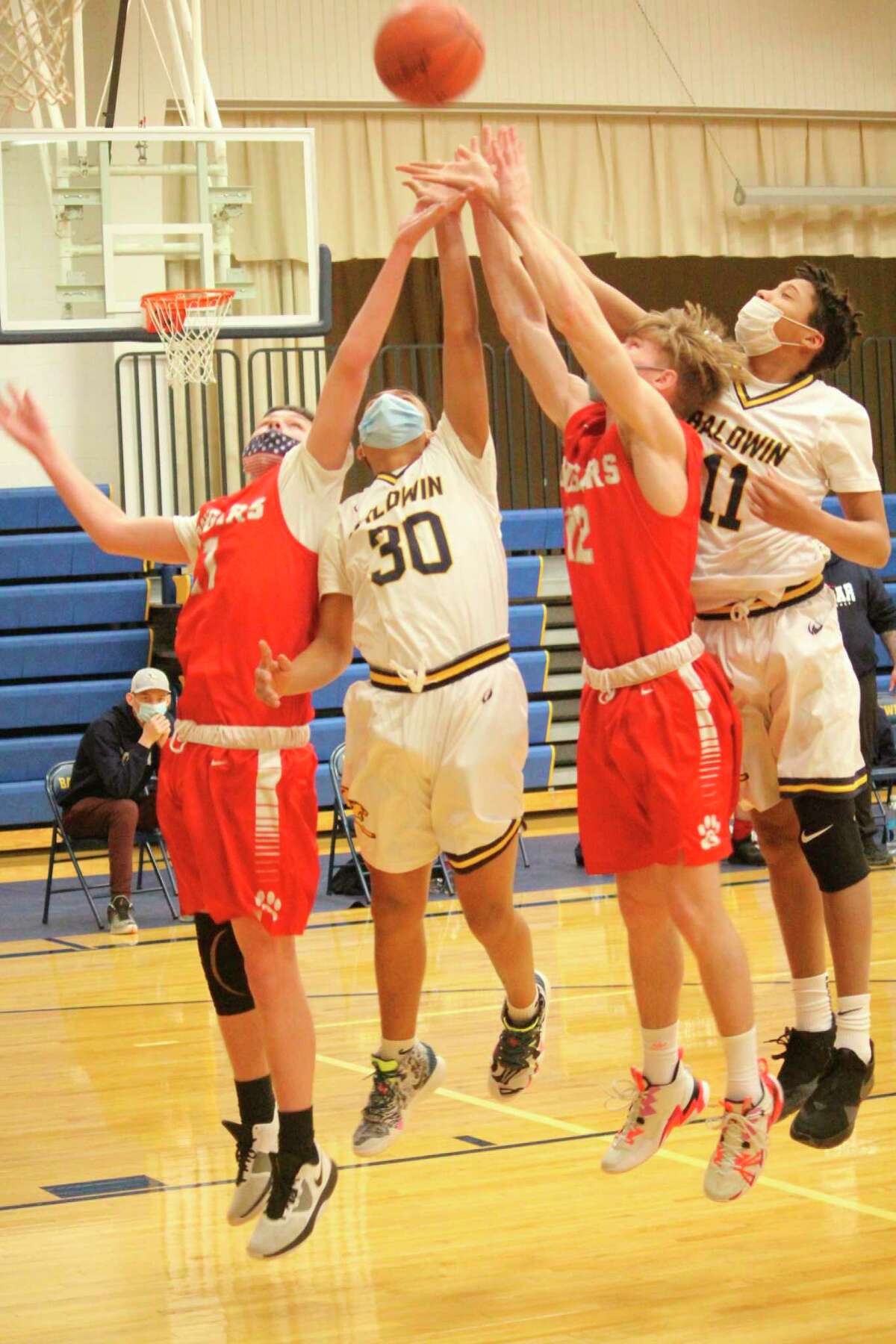 Baldwin's SJ Hossler (30) and Karlito McKinney (11) battle for the ball against CCA on Friday. (Star photo/John Raffel)