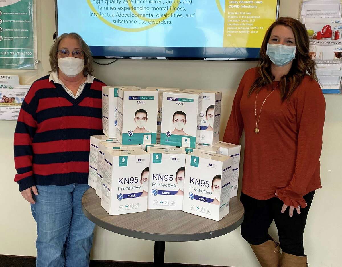 Michigan Department of Health and Human Services recently distributed 8,400 KN95 protective masks to 32 residential group home providers in Mason, Lake and Oceana counties as part of its the Mask Up, Mask Right campaign. West Michigan CMH assisted MDHHS with the local distribution. Pictured is Deb Davis (left), manager of the Samaratis group home in Scottville, accepting the masks from Nicole Kusebuski, network and QI specialist at West Michigan CMH. (Courtesy photo/Michigan CMH)