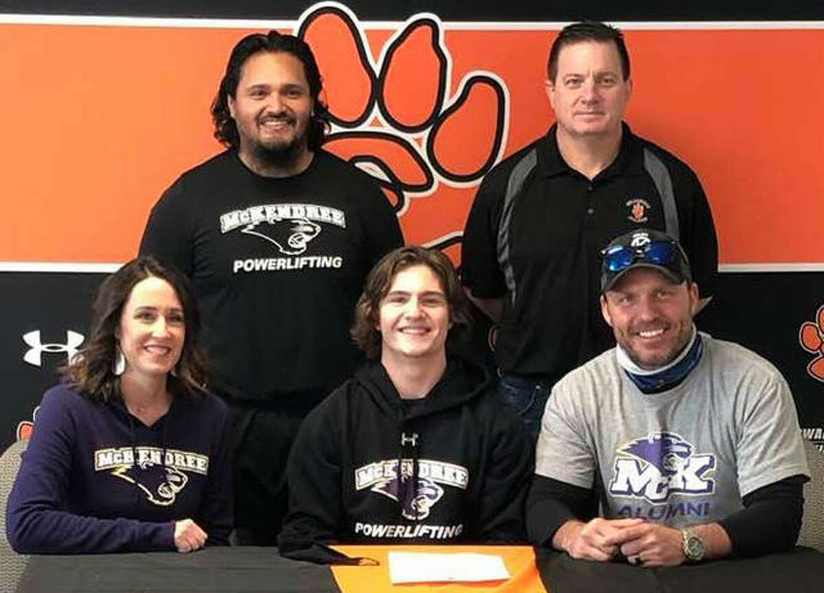 Edwardsville High School senior Maxon Karnes, seated center, will compete for the powerlifting team at McKendree University. He is joined by his parents, EHS wrestling coach Jon Wagner and McKendree powerlifting coach Guillermo Blanco.