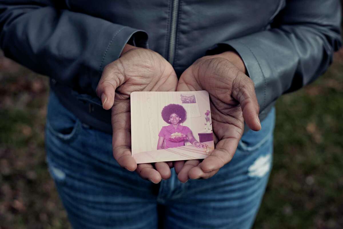 Alena Baker holds a picture of her mother, Sylvia.