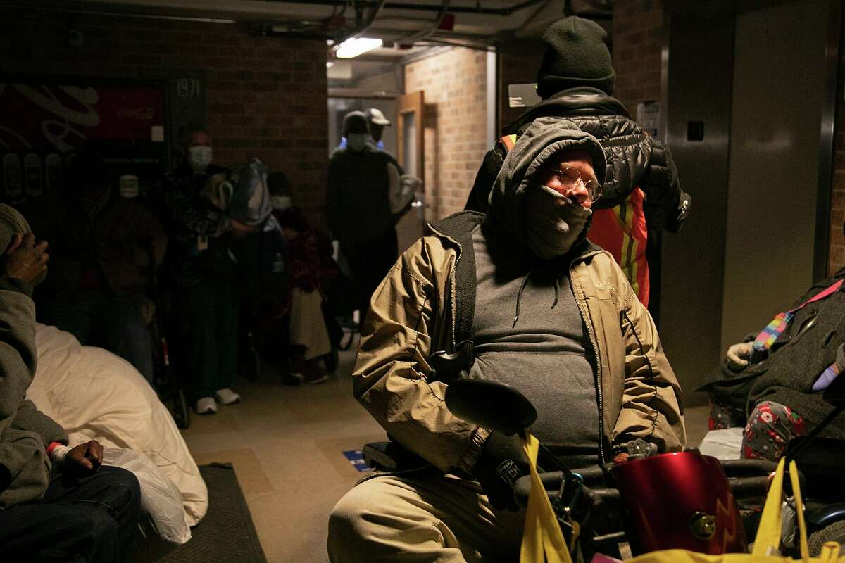 Timothy Arnold, 60, a disabled veteran, waits with other residents at Fair Avenue Apartments for VIA buses to arrive to transport residents to a downtown hotel. An emergency generator provided electricity for the elevator, lobby and some hallways.
