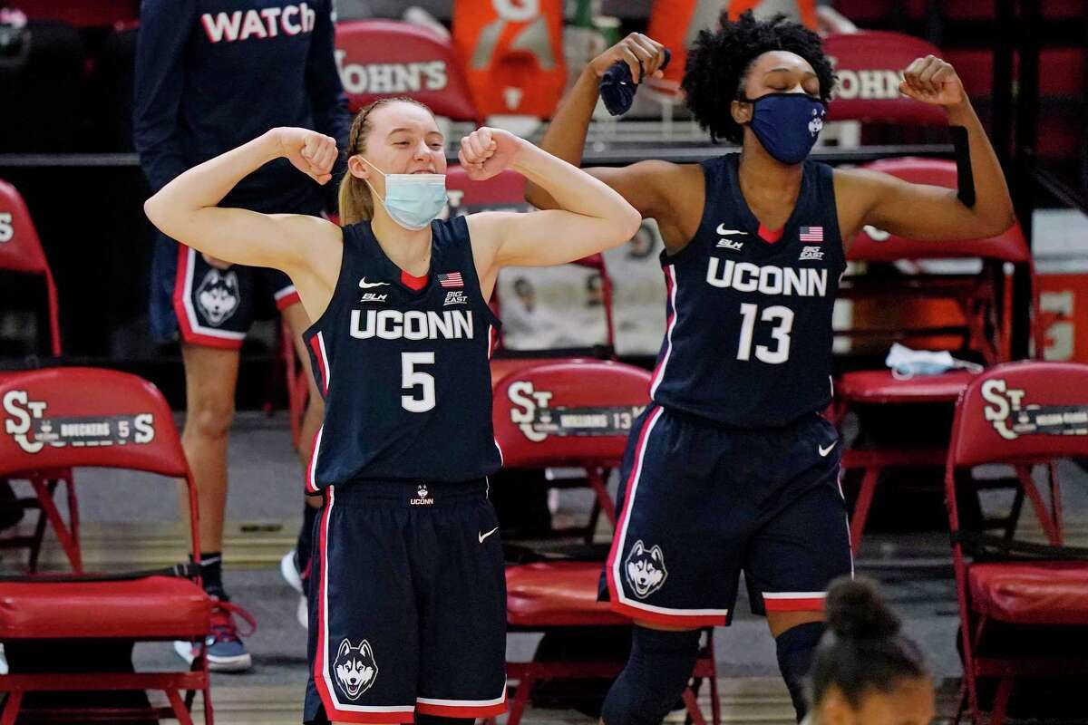 UConn's Paige Bueckers (5) and Christyn Williams (13) react from the bench during the fourth quarter of the Huskies' 77-32 win at St. John's on Wednesday.