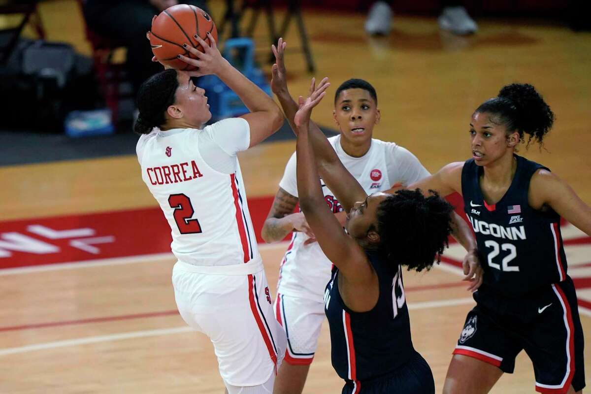 St. John's guard Leilani Correa (2) shoots while defended by UConn's guard Christyn Williams (13) on Wednesday in New York.