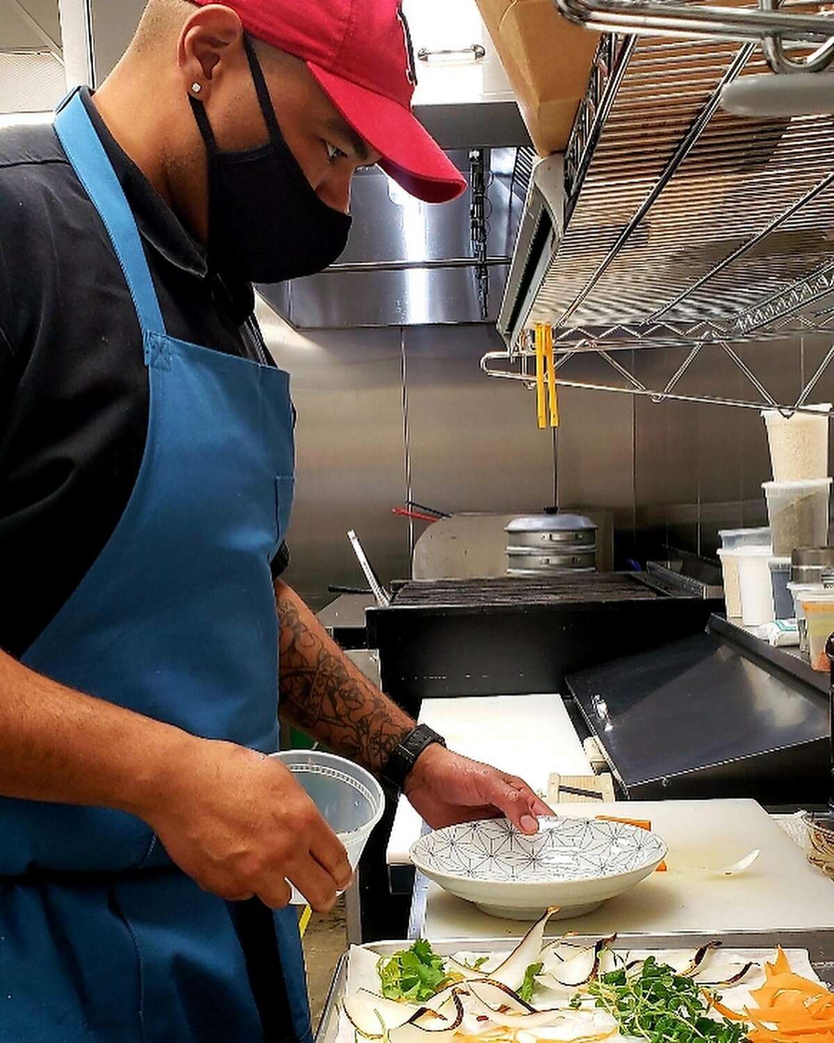 Edwin Bayone III prepares food at Bap, his new virtual kitchen. The executive chef of the modern Korean restaurant Um.ma in San Francisco operates out of a CloudKitchen space in the Bayview, it opened for takeout and delivery Feb. 1, 2021 with a focus on Korean rice dishes.