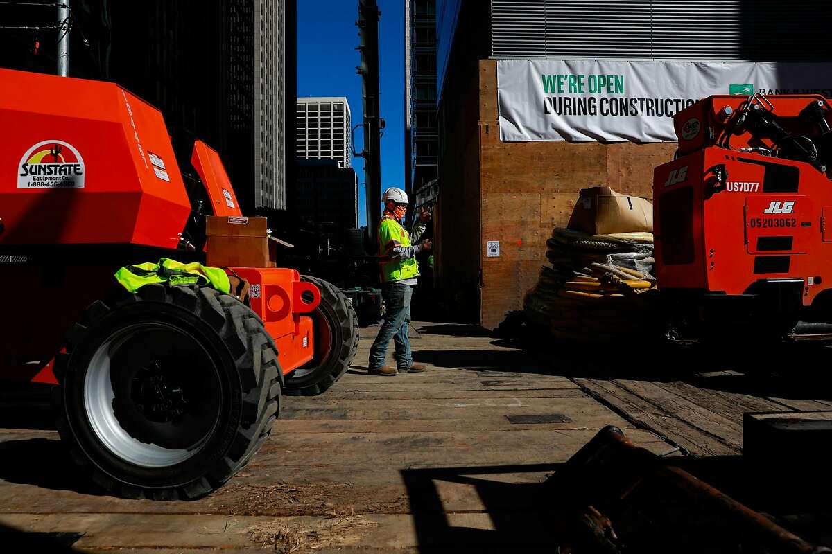 Laborers work to fix the foundation of Millennium Tower on Mission Street.
