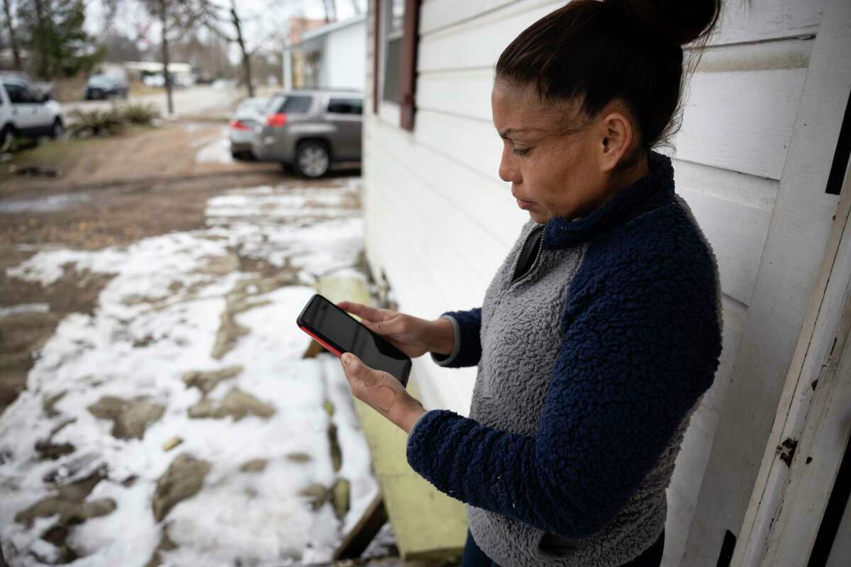 Maria Pineda, looks through the photo gallery of her phone searching for images of her son, 11-year-old Cristian Pavon Pineda, Thursday, Feb. 18, 2021, in Conroe. It is suspected that Pavon Pineda died from hypothermia as temperatures plummeted into the teens on Tuesday, Feb. 16.