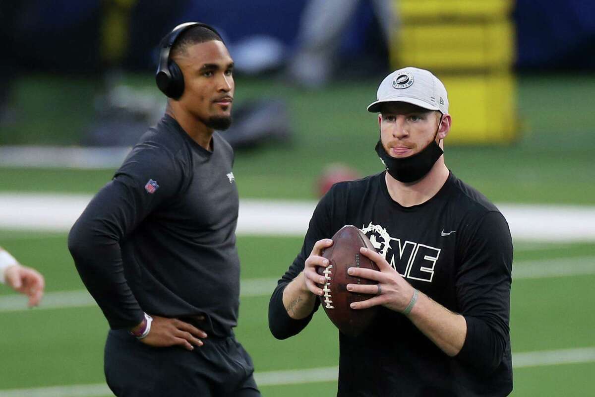 The Eagles made the transition to Jalen Hurts, left, as their quarterback complete by trading Carson Wentz, right, to Indianapolis.