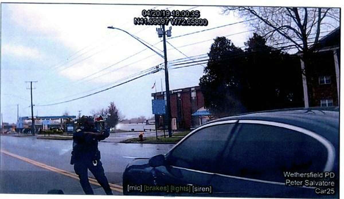 Former Wethersfield police Officer Layau Eulizier is captured on a fellow officer's dashcam firing at a car during an officer-involved-shooting in Wethersfield, Conn. on April 20, 2019. The father of Anthony Vega-Cruz, the 18-year-old fatally shot in the incident, is suing the town of Wethersfield and Eulizier in federal court, alleging wrongful death.