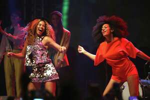INDIO, CA - APRIL 12: Singers Beyonce (L) and Solange perform onstage during day 2 of the 2014 Coachella Valley Music &amp; Arts Festival at the Empire Polo Club on April 12, 2014 in Indio, California. (Photo by Imeh Akpanudosen/Getty Images for Coachella)