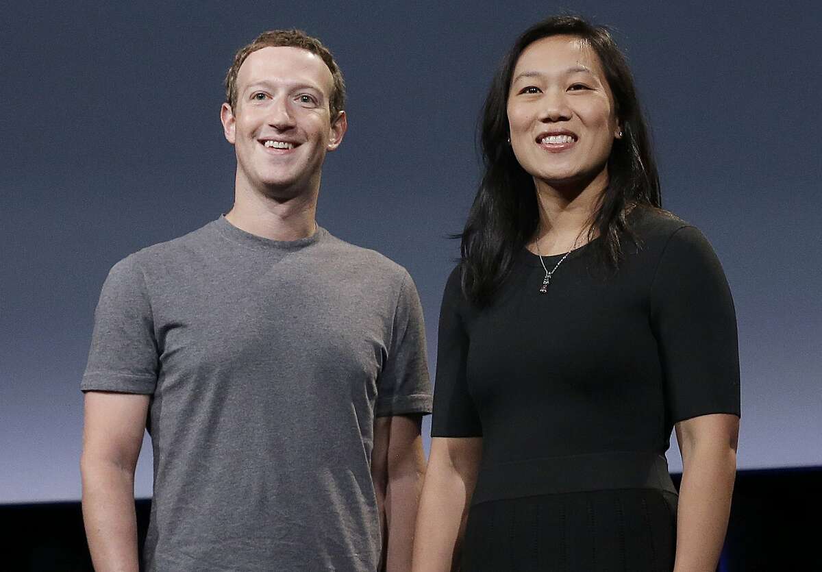 Facebook CEO Mark Zuckerberg and his wife, Priscilla Chan, smile as they prepare for a speech in San Francisco, Sept. 20, 2016. 