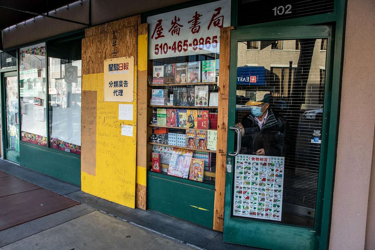 Owner Daniel Wong closes the partially barricaded Oakland Chinese Book Store.