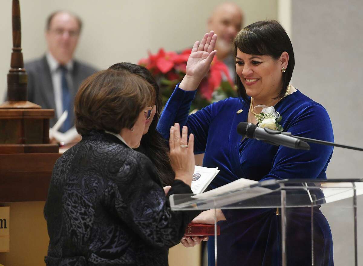 Newly elected City Councilwoman Maria Pereira is sworn in by ex-judge Carmen Lopez during the swearing in ceremony of city officials at City Hall in Bridgeport, Conn. on Thursday, November 28, 2019.