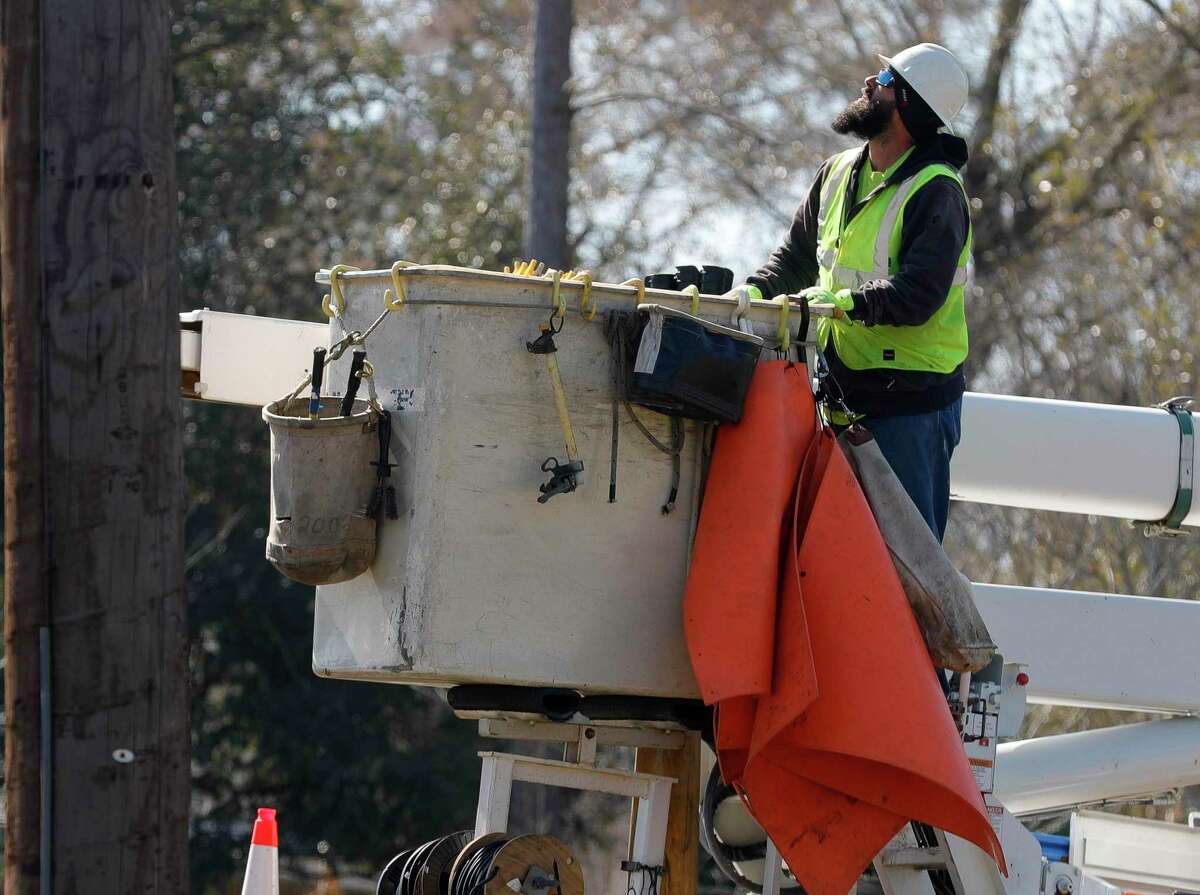 Bright Star Solutions utility line contractors workers on power lines for a nearby subdivision, Friday, Feb. 18, 2021, in Montgomery.