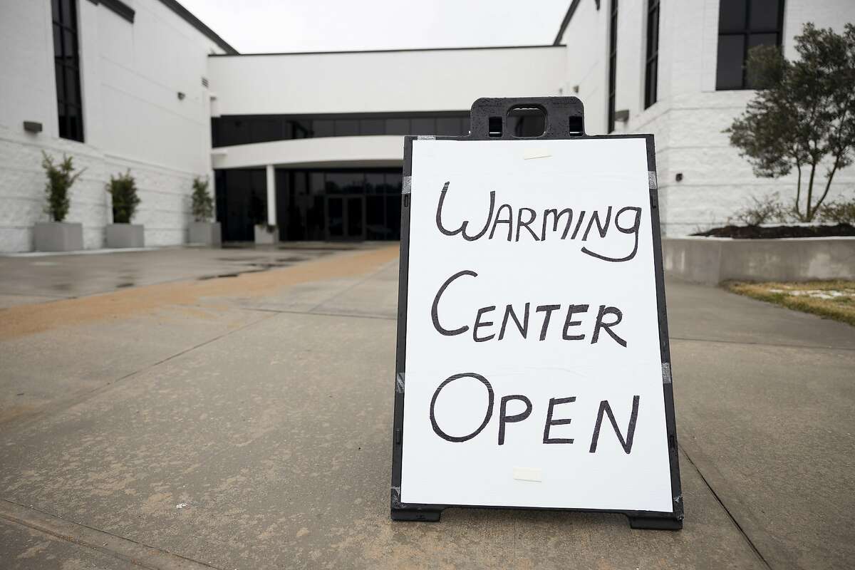 An open sign is seen at the Church Project, Thursday, Feb. 18, 2021, in The Woodlands. People as far as Friendswood were transported to the warming center due to outages in their area and hotels being at max capacity.