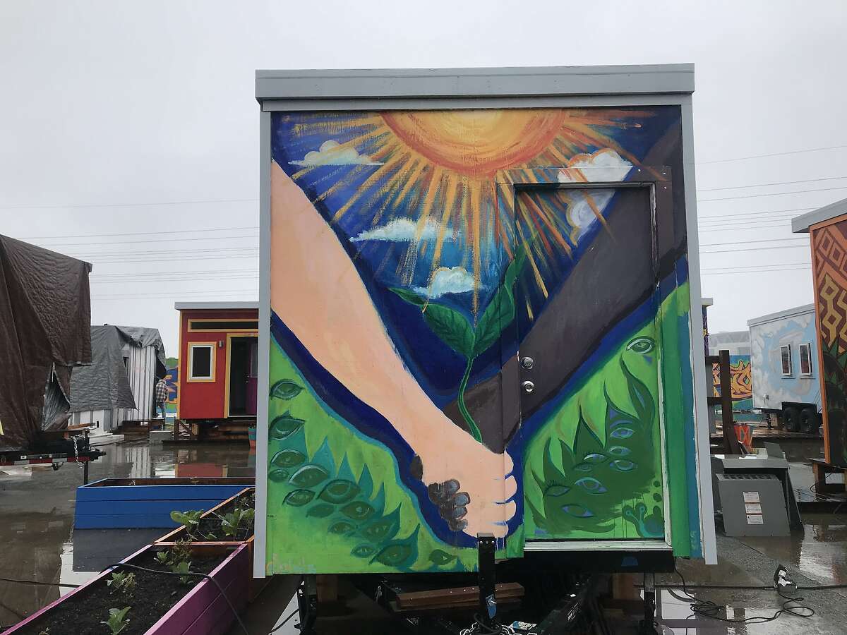 The 8-by-10-foot homes have electricity and heated floors. Each has a bed that can fold into the wall and become a desk. Williams-Sonoma donated rugs and sheets, and artists painted murals on the tiny homes.