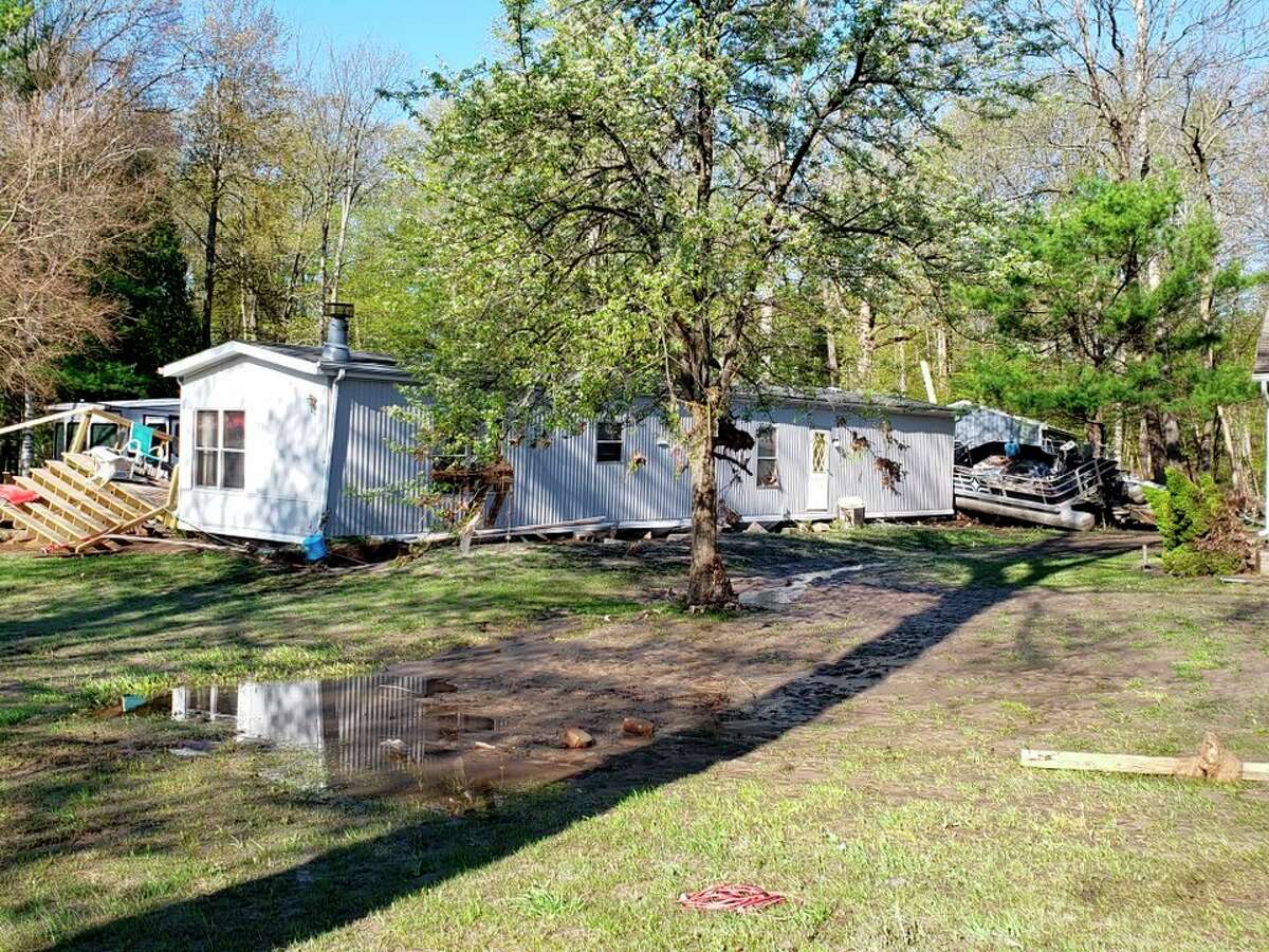 "Our mobile home was strapped down with hurricane straps, but it still moved 20 feet off the foundation and twisted the frame," Sharon said. "There was a pontoon leaning against our house. It wasn't our pontoon…it had washed up on our property. All I can say is it was heart-wrenching. We were in pure shock." (Photo Provided)