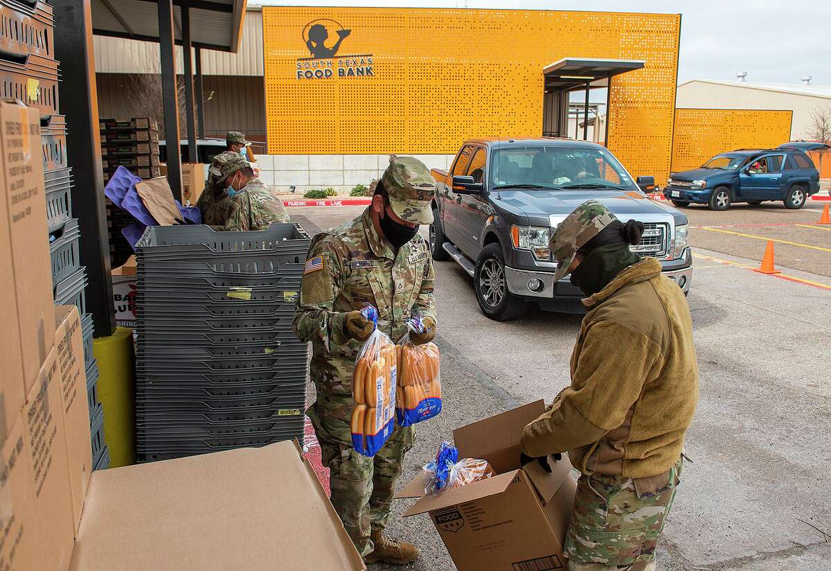 Members of the Texas National Guard help the South Texas Food Bank distribute food to Laredoans affected by the extreme cold and power outages, Thursday, Feb. 18, 2021 at the STFB facility.
