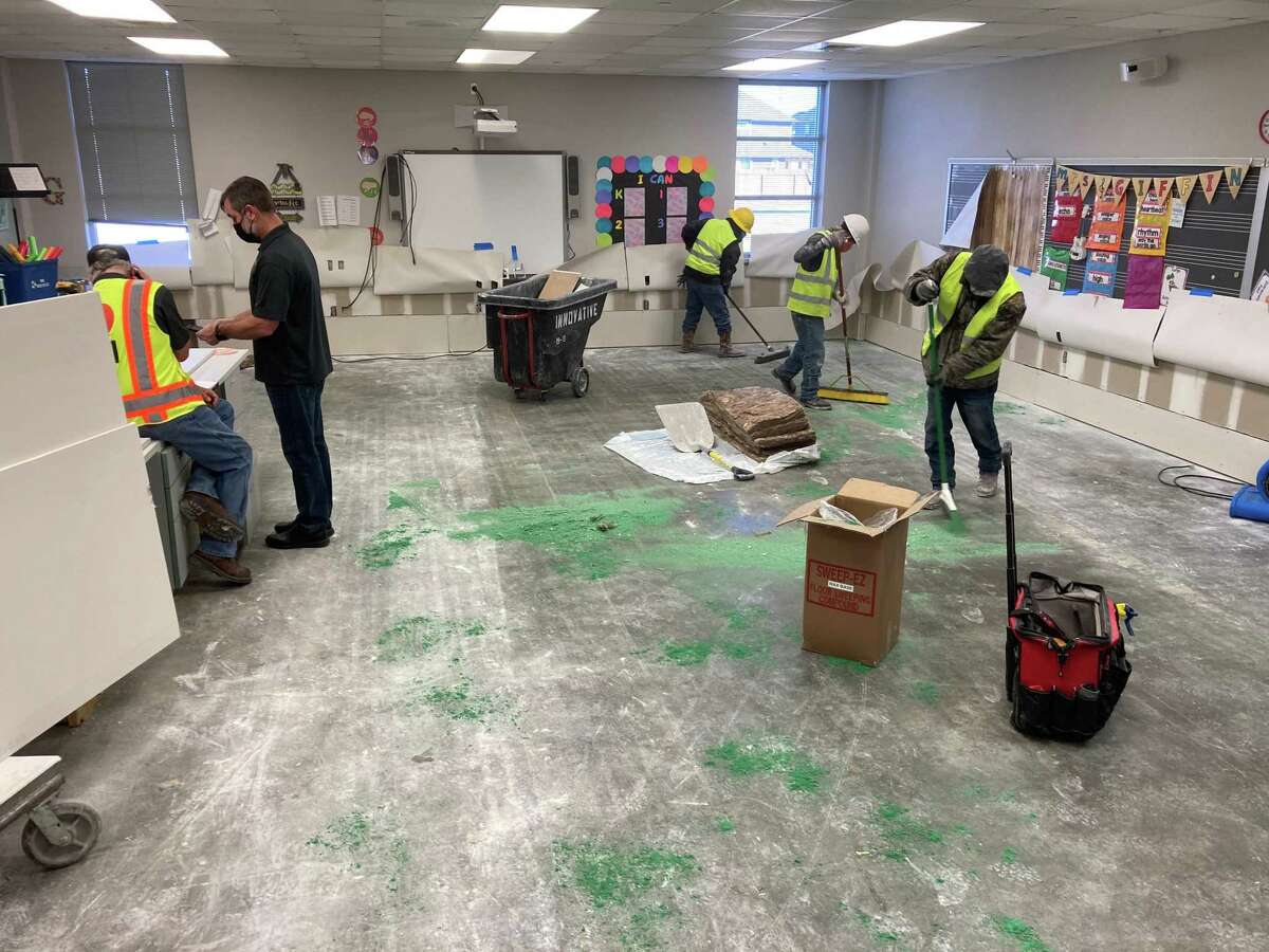 A crew works in a classroom at Schmalz Elementary on Friday, Feb. 19, to clean up damages left behind by the Texas winter blast. Katy Independent School District is slated to resume classes on Monday, Feb. 22.