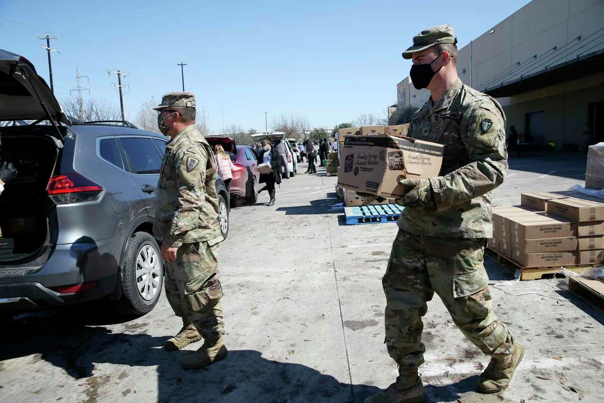 Soldiers with the Texas National Guard 36th Infantry Division help with food distribution at the San Antonio Food Bank, Friday, Feb. 19, 2021.