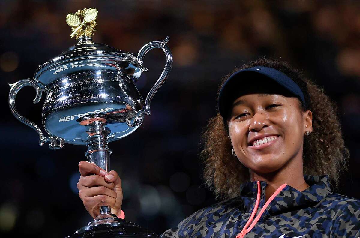 Japan's Naomi Osaka holds the Daphne Akhurst Memorial Cup after defeating United States Jennifer Brady in the women's singles final at the Australian Open tennis championship in Melbourne, Australia, Saturday, Feb. 20, 2021.