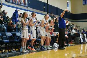 Friendswood players and head coach Daron Scott react to a play on the court against Angleton Friday at Friendswood High School.