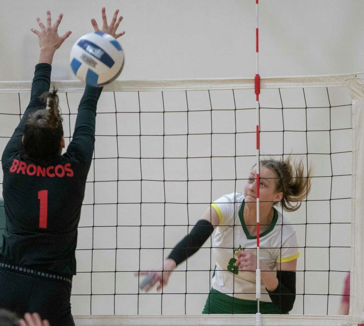 Midland College's Lucie Maceckova gets a hit past the reach of NMMI's Marian Ovalle 02/20/2021 in the gym at Midland College Physical Education building. Tim Fischer/Reporter-Telegram
