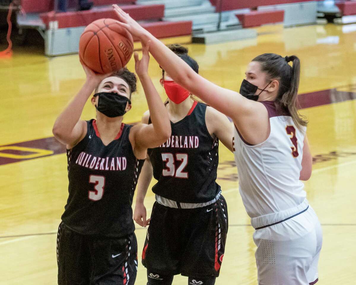 Colonie defender Megan Dwire gets a hand on a layup by Guilderland senior Valencia Fontenelle Posson during a Suburban Council matchup at Colonie High School in Colonie, NY, on Saturday, Feb. 20, 2021 (Jim Franco/special to the Times Union.)