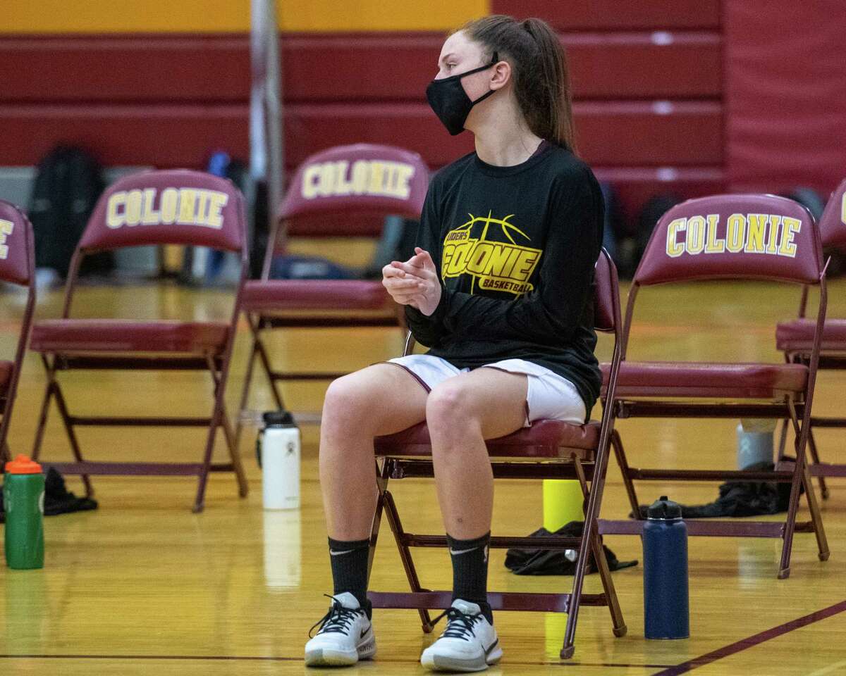 Colonie standout Macie Trimarchi is forced to sit on the bench and cheer for her team during a Suburban Council match up against Guilderland on Saturday, Feb. 21, 2021, because of a COVID related delay to her season (Jim Franco/special to the Times Union.)
