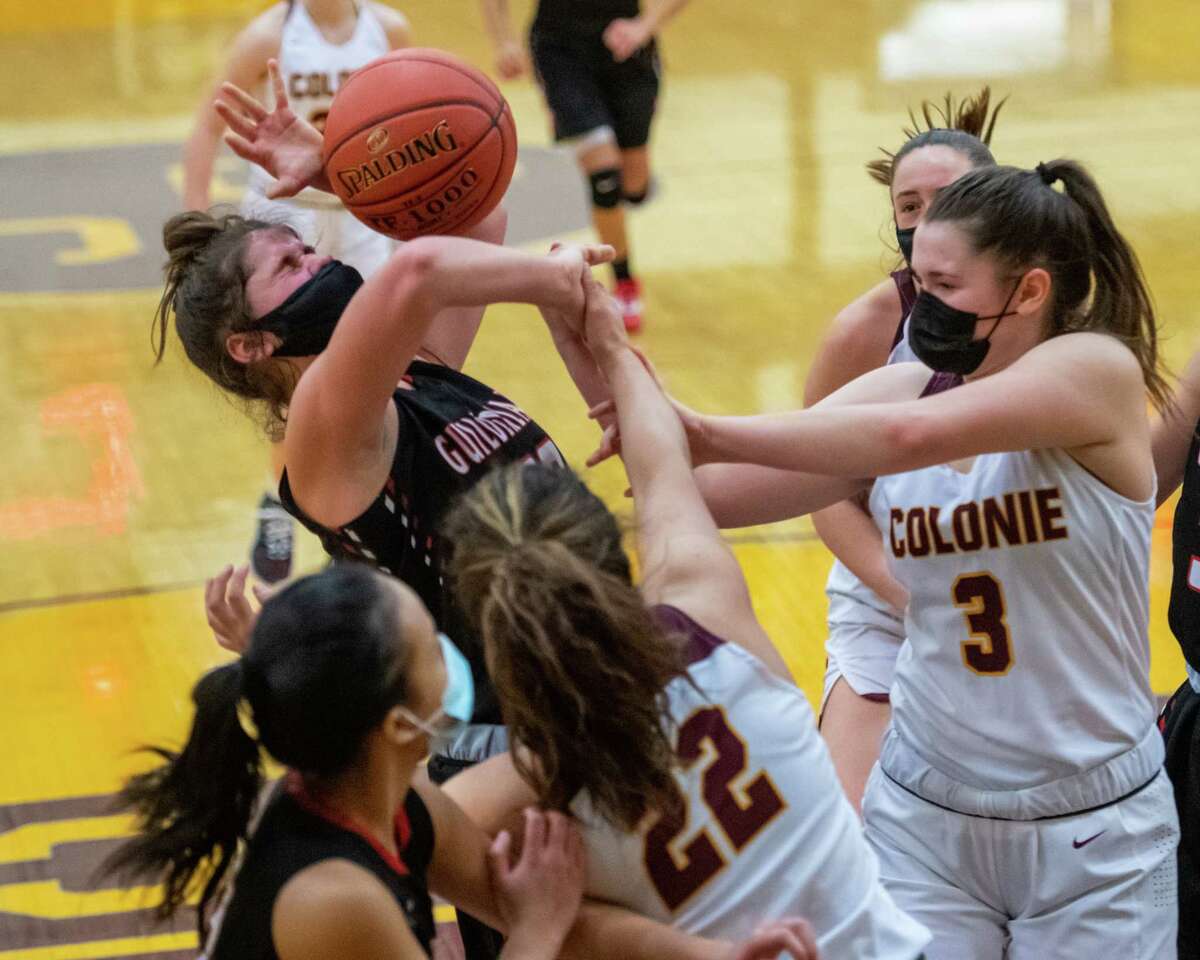 Guilderland freshman Sophia Serravillo battles for a loose ball with Colonie's Megan Dwire (no. 3) during a Suburban Council matchup at Colonie High School in Colonie, NY, on Saturday, Feb. 20, 2021 (Jim Franco/special to the Times Union.)