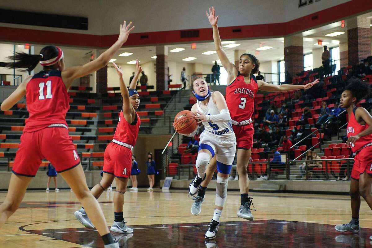 Clear Springs’ Kylie Minter (5) tries to lay up a shot past Atascocita’s Kori Fenner (3) Saturday, Feb. 20 at La Porte High School.