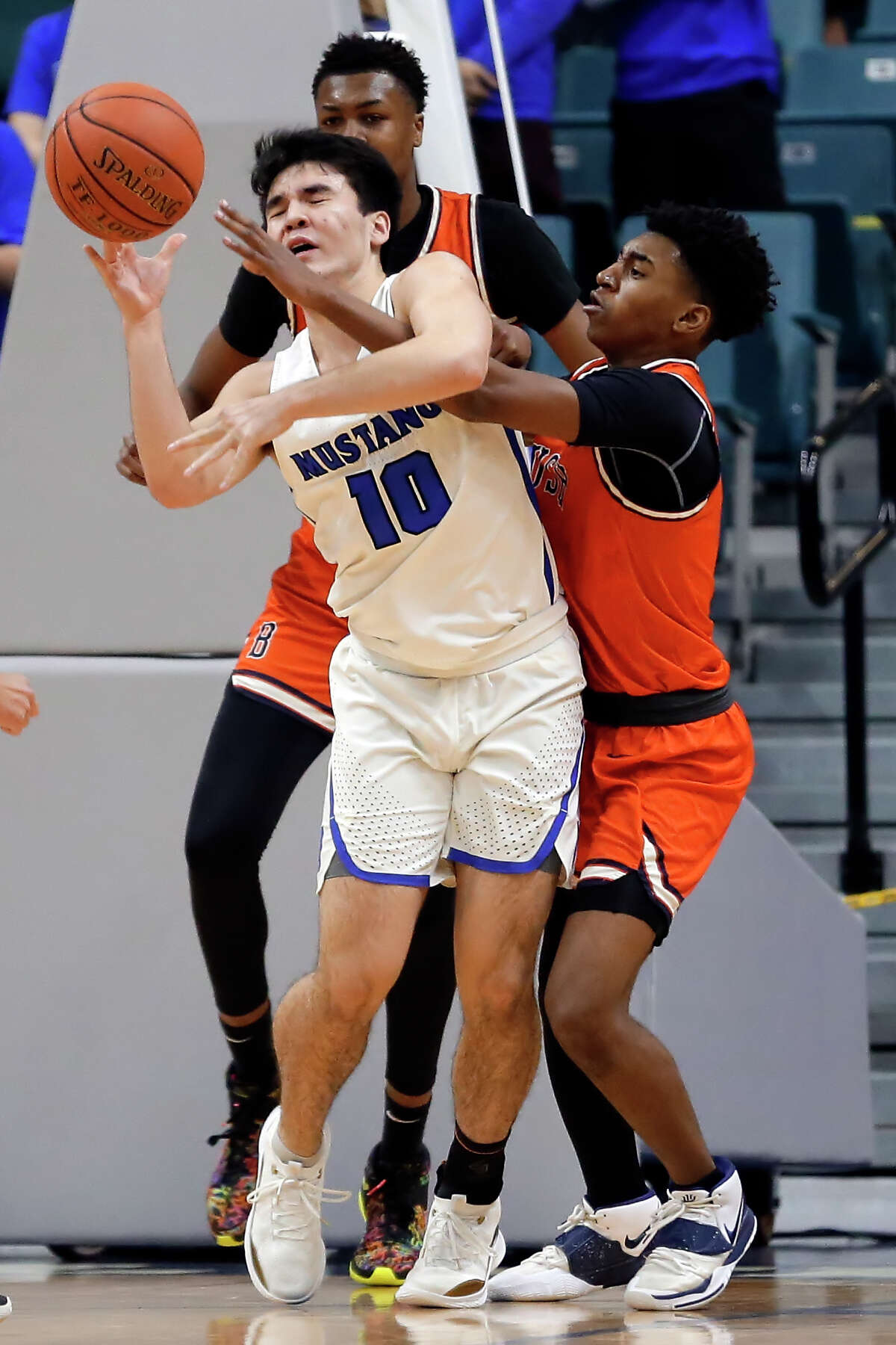 Katy Taylor's Jake Armold (10) is fouled as he passes the ball by Bush's Zion Bourgeois, right, during a 6A district boys high school basketball playoff game Saturday, Feb. 20, 2021 at the Merrell Center in Katy, TX.