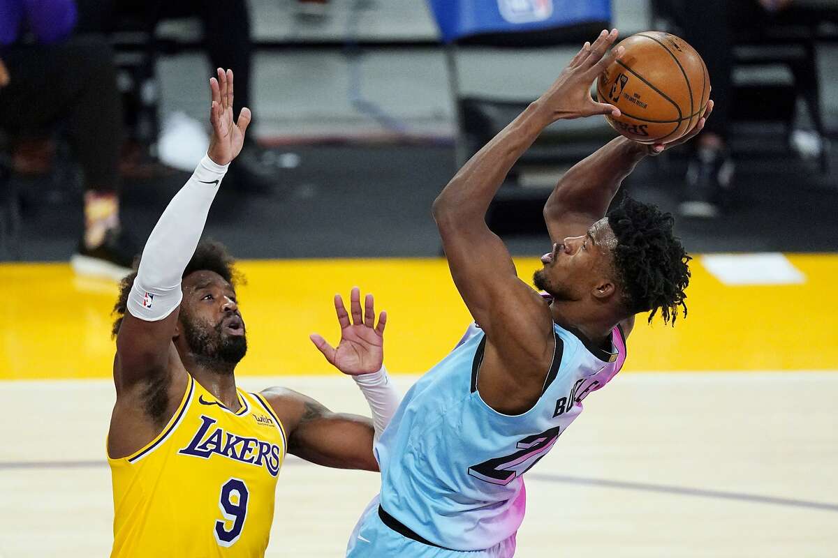 Heat forward Jimmy Butler (right), who scored 24 points and grabbed 8 rebounds, shoots against Lakers guard Wesley Matthews.