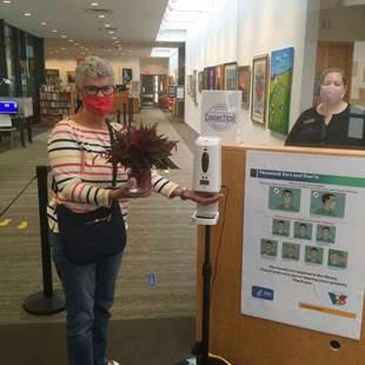 Wilton Library patron Patrice Banahan, left, was welcomed by Library Circulation Manager Karen Zeibak when the library first introduced its Express Services this past fall. The Wilton Library's Express Services resume on Monday, Feb. 8, with appointments that can be scheduled on Mondays through Saturdays, from 11 a.m. to 3 p.m. The appointments are twenty minutes to allow for the cleaning of service desks between patrons.