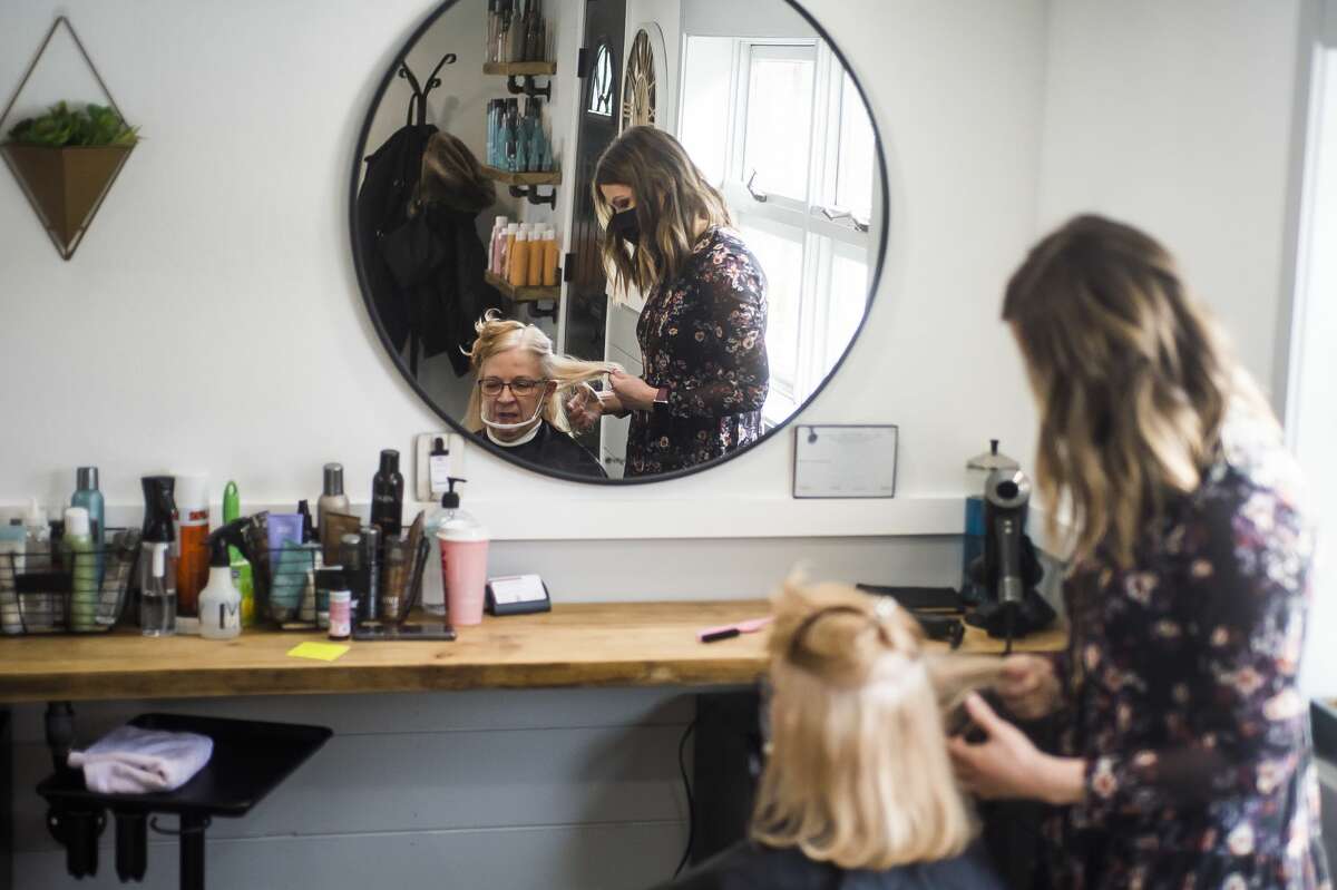 Sam Walser, co-owner of Northwest Hairstyles, works with a client, Barb Patrick, Tuesday, Feb. 16, 2021 at the salon in Midland. (Katy Kildee/kkildee@mdn.net)