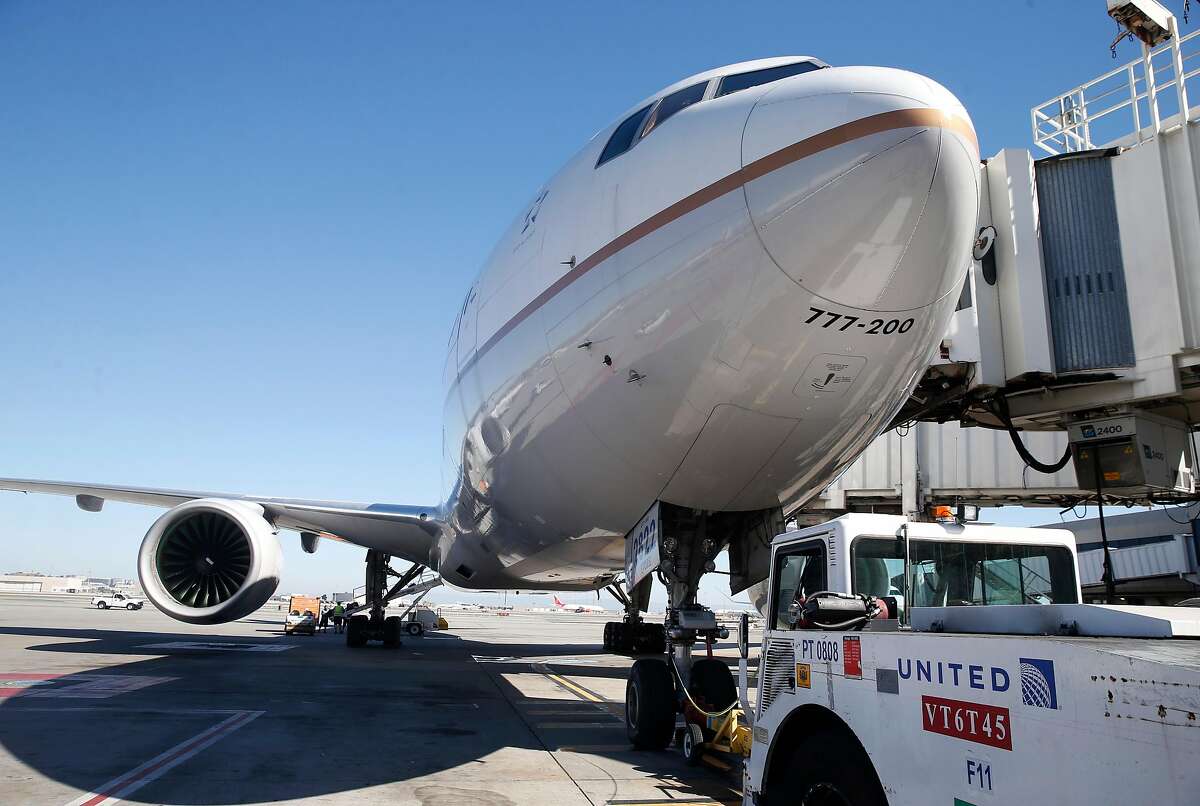 A United Airlines Boeing 777 is readied for departure to Honolulu from gate F11 at SFO in San Francisco, Calif. on Thursday, Oct. 15, 2020. As the airline industry sees a modest rise in travel, a rapid COVID-19 testing site has been set up at the airport to provide travelers with documentation of test results to present upon arrival at their final destinations.