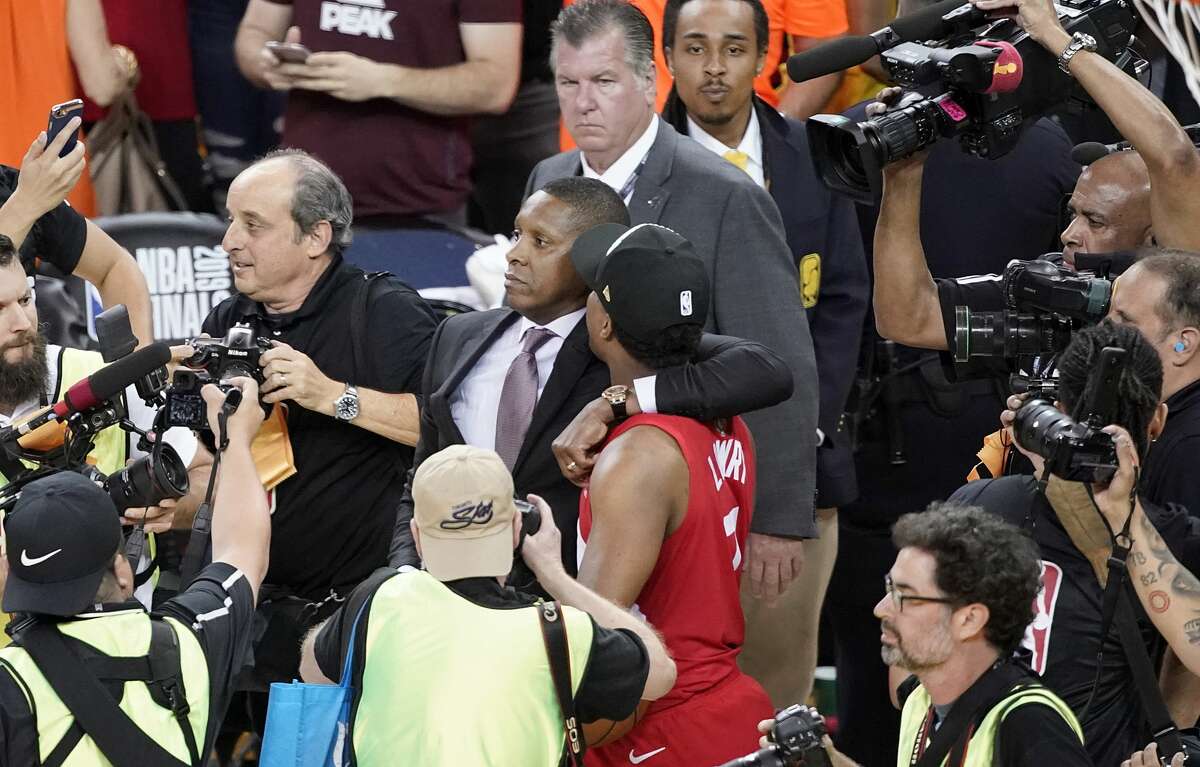 Toronto Raptors President Masai Ujiri walking with guard Kyle Lowry after the Raptors defeated the Golden State Warriors in Game 6 of the 2019 NBA Finals in Oakland, Calif.