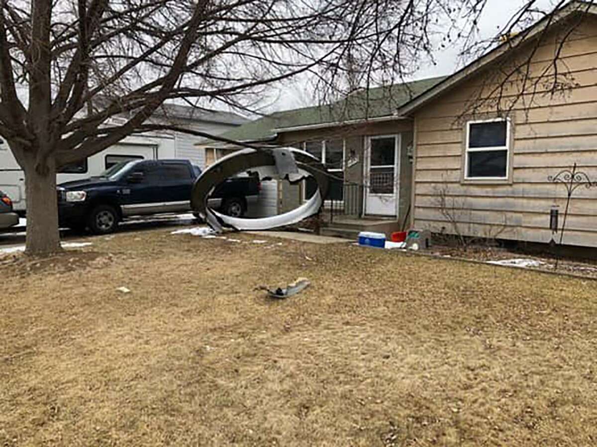 A courtesy photo from the Broomfield Police Department shows aircraft debris in the front yard of a Broomfield, Colorado, home. (Broomfield Police Department/TNS)