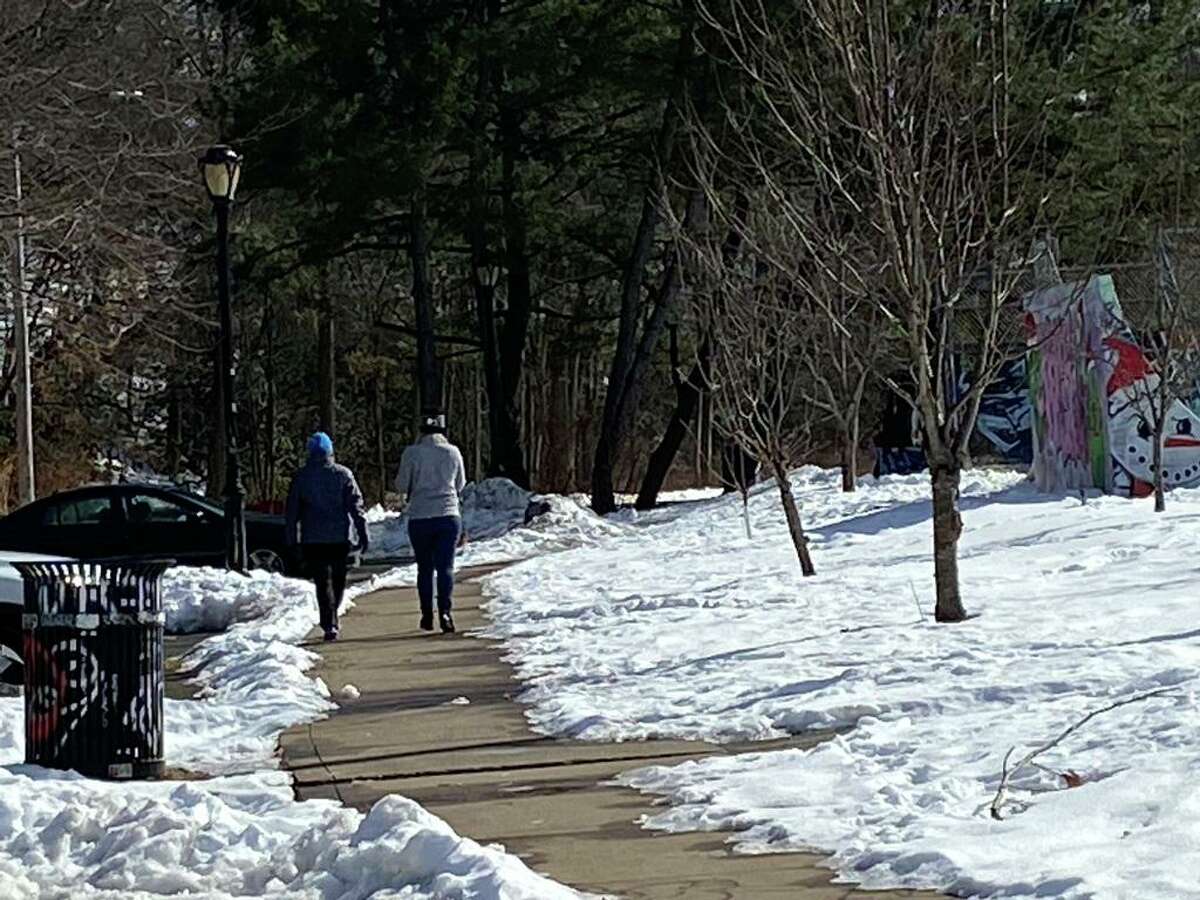 Walkers take advantage of a bright, clear day to stroll along a wooded trail in New Haven’s Edgewood Park. Scientists and medical providers are becoming increasingly impressed by how the simple act of spending time outdoors in a natural setting can lead to improved physical and mental health.