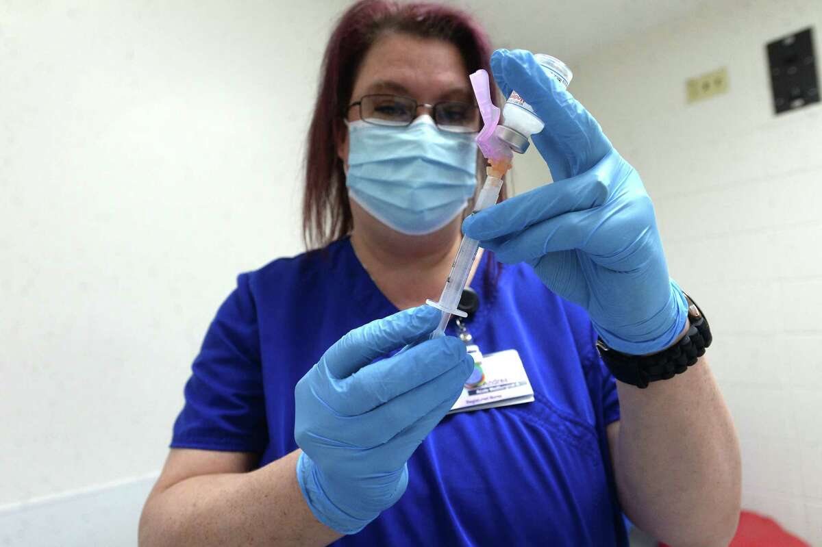 Andrea Spears fills a syringe with the 1/2 millimter dose of the Moderna COVID-19 vaccine at Christus of Southeast Texas Jasper Memorial Hospital Tuesday as first shots for healthcarre workers got underway. Photo taken Tuesday, January 5, 2021 Kim Brent/The Enterprise